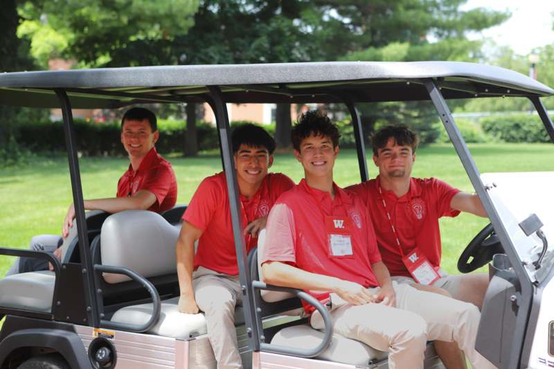 a group of men in a golf cart