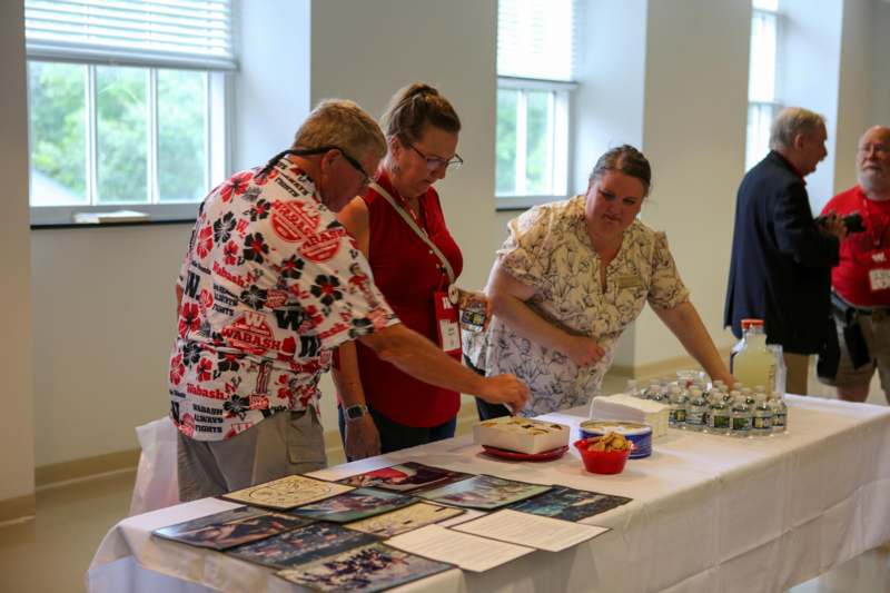 a group of people standing around a table