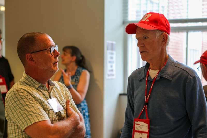 a man in a red hat talking to a man in a red hat