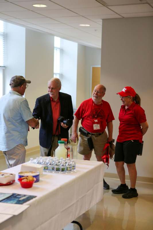 a group of people standing around a table