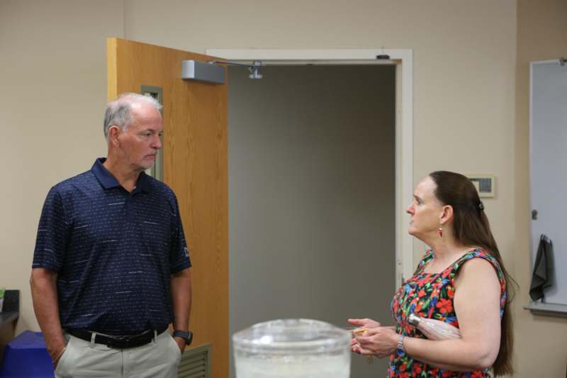 a man and woman standing in a room
