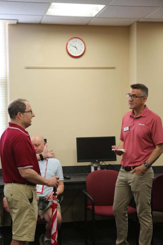 men in a room talking to each other