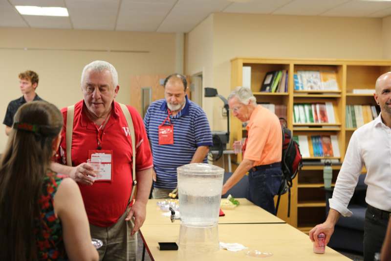 a group of people standing around a table