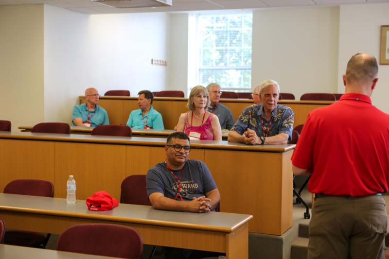 a group of people sitting in a lecture hall