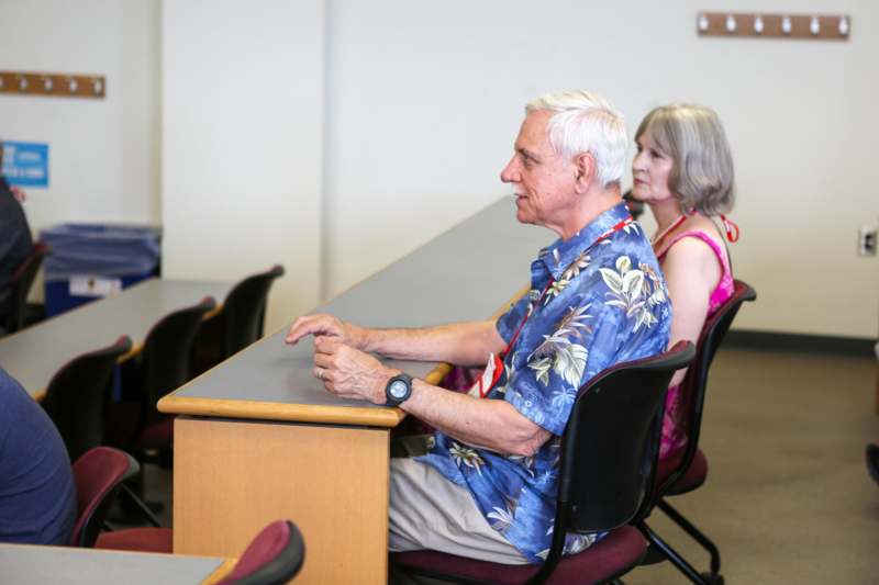 a man and woman sitting at a desk