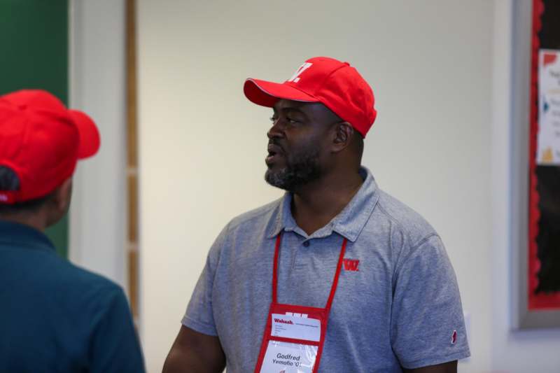 a man wearing a red hat and lanyard