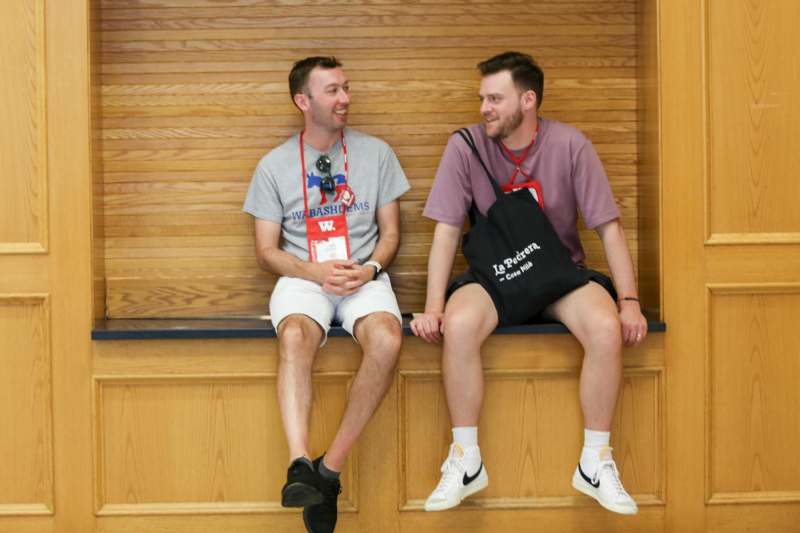 two men sitting on a bench