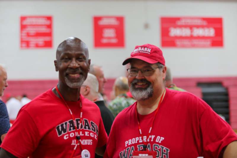 two men wearing red shirts
