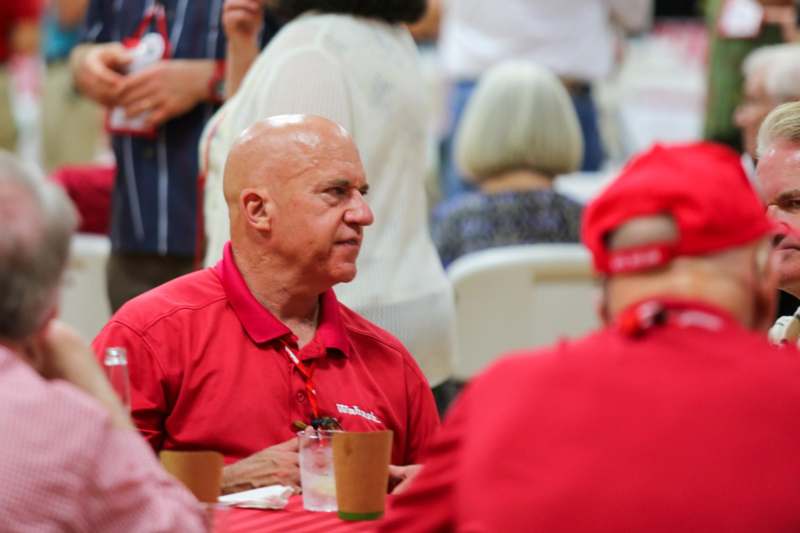 a man in red shirt sitting at a table