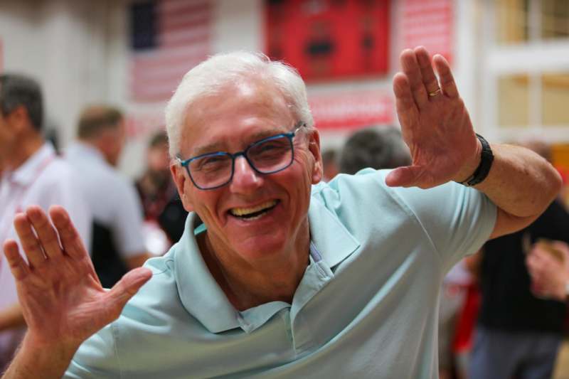 a man with glasses and a blue shirt