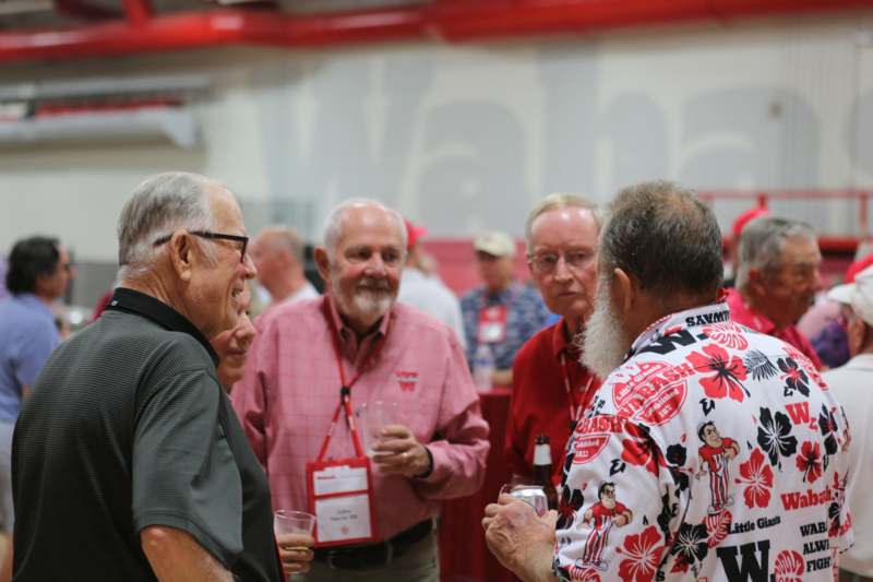 a group of men talking in a room