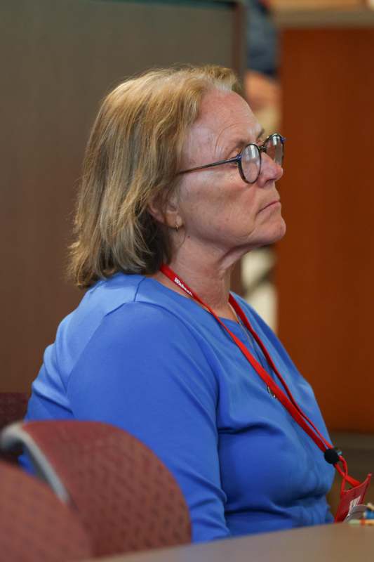 a woman wearing glasses and a blue shirt