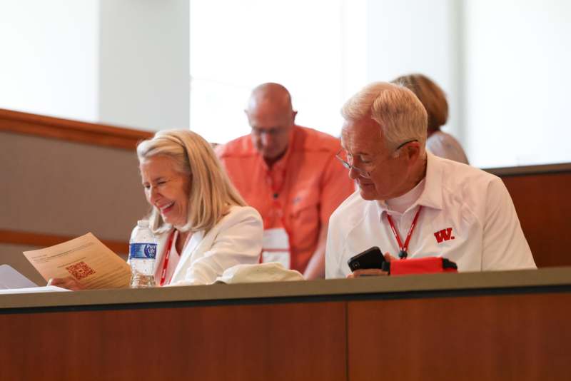 a group of people sitting at a desk