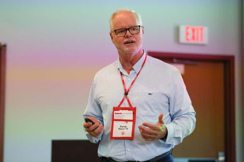 a man wearing a lanyard and holding a phone