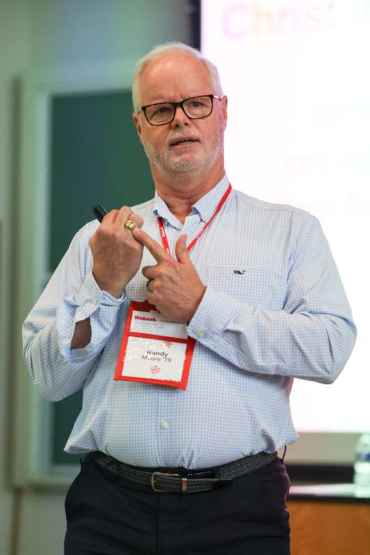 a man wearing a badge and holding a pen