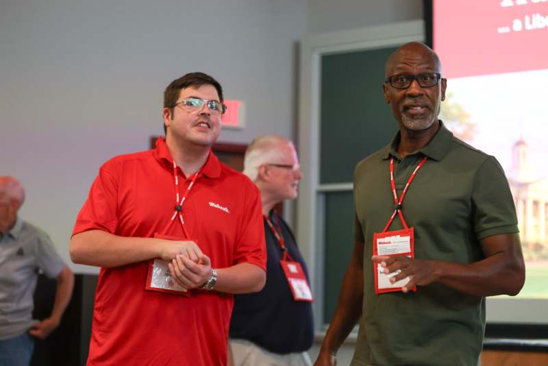 a group of men wearing lanyards