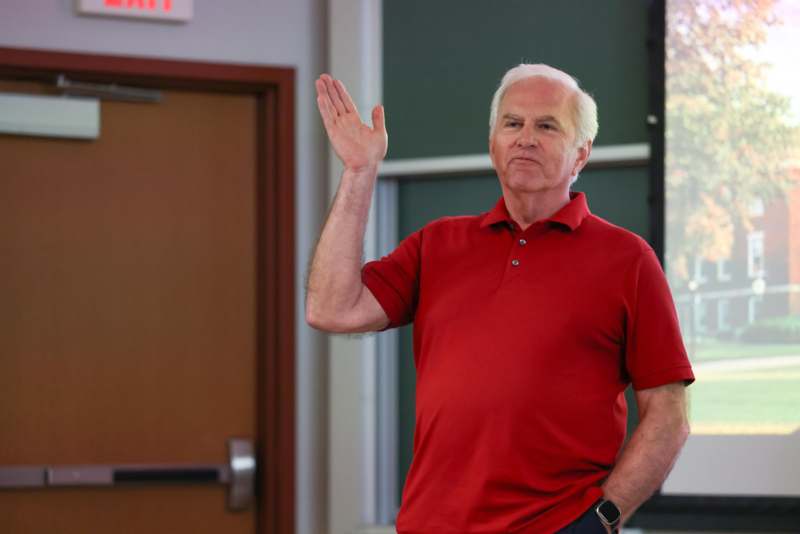 a man in a red shirt waving