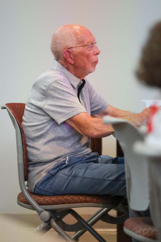 an old man sitting in a chair
