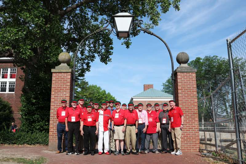 a group of people standing under a gate