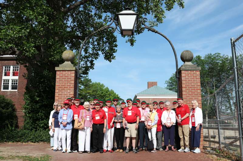 a group of people standing in front of a brick archway