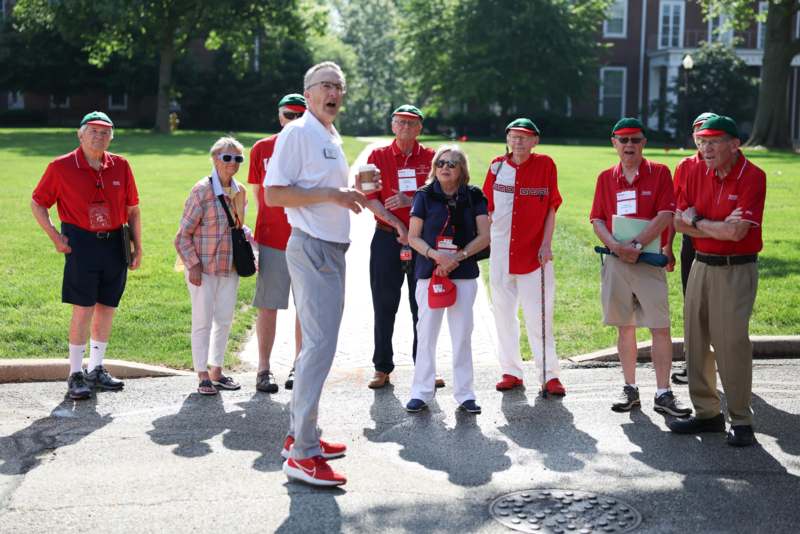 a group of people standing on a sidewalk