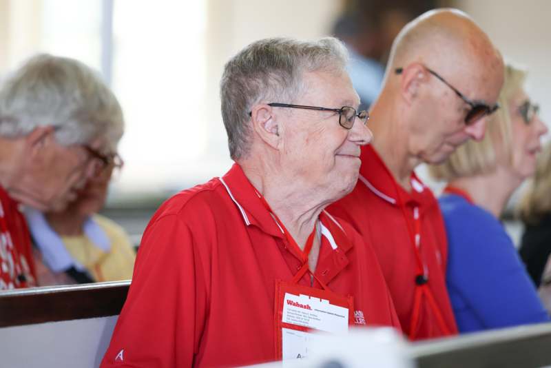 a group of people in red shirts