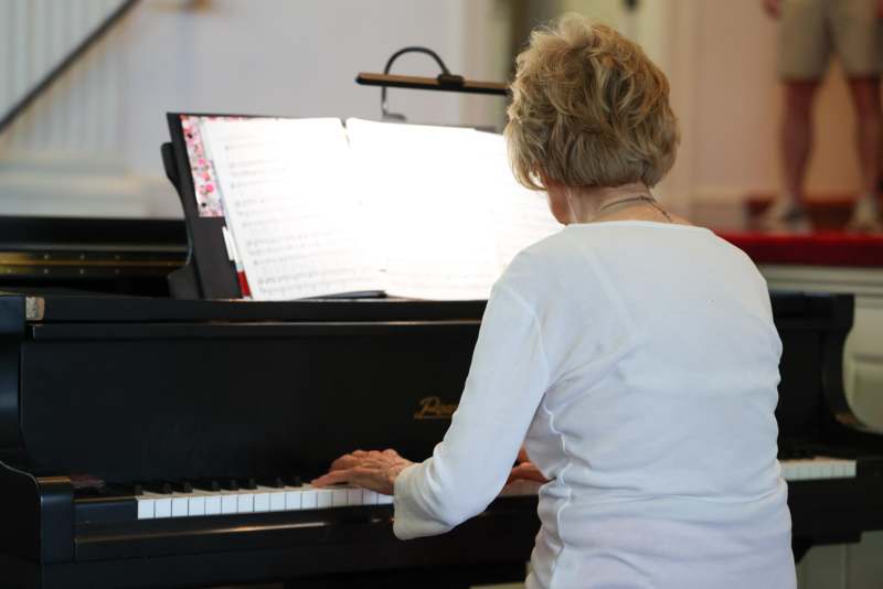 a woman playing a piano