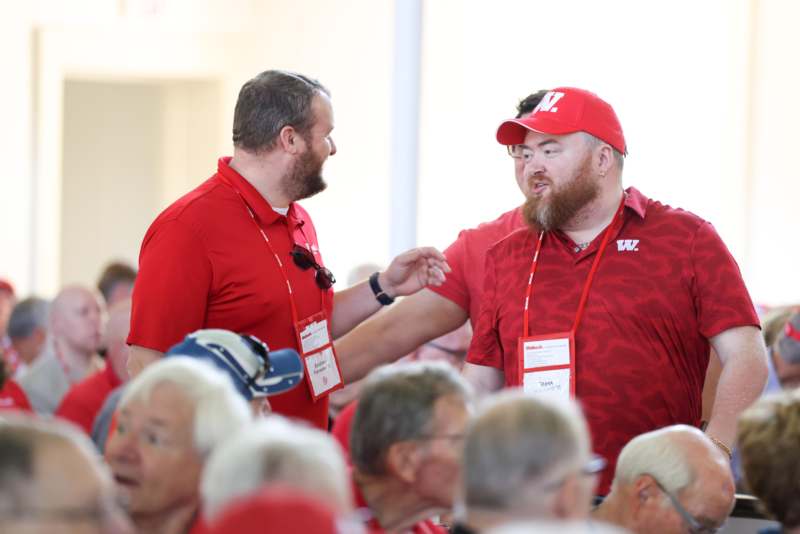 a group of men in red shirts