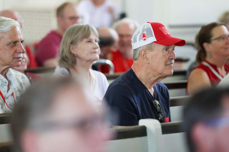 a group of people sitting in pews