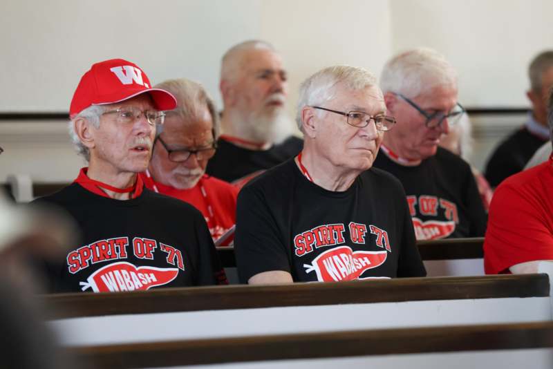 a group of men sitting in pews