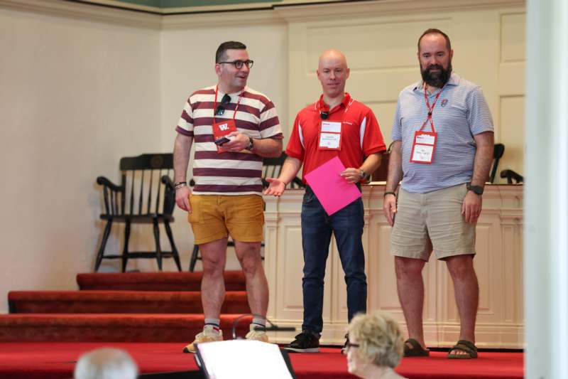 a group of men standing on a stage