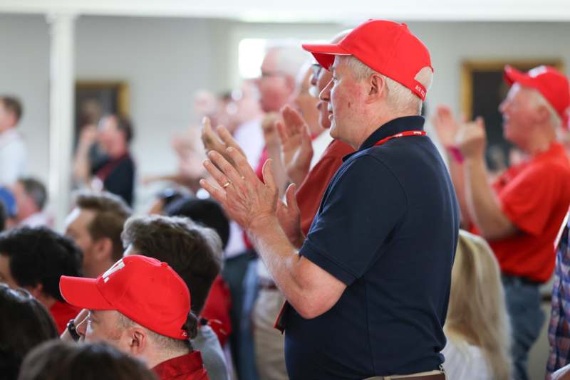 a man in a red hat clapping