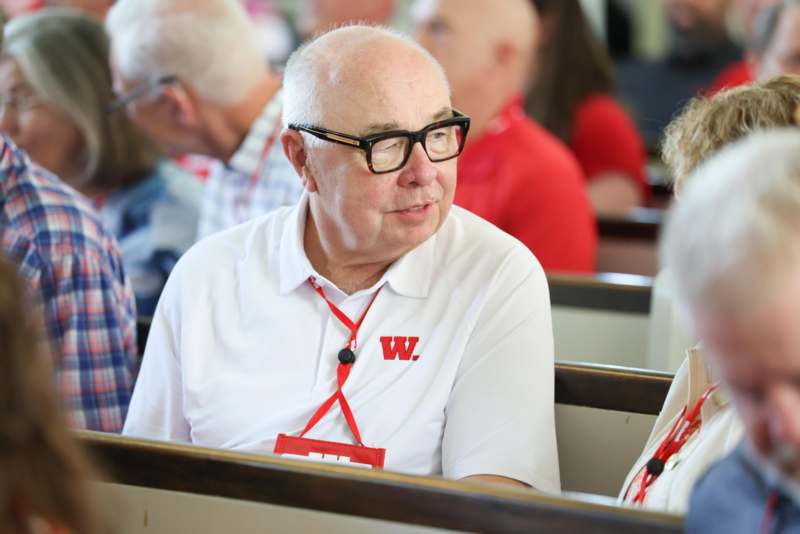 a man wearing glasses and a white shirt