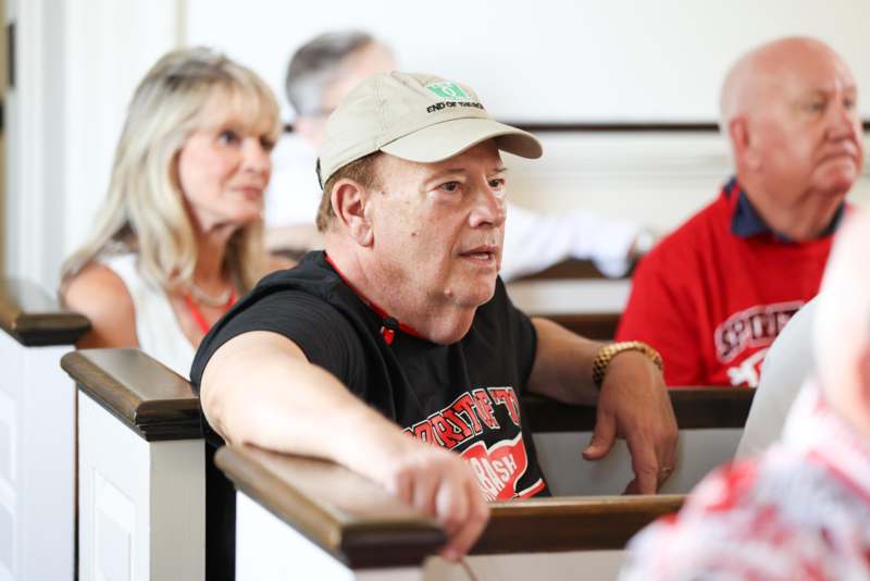 a man in a hat sitting in a church