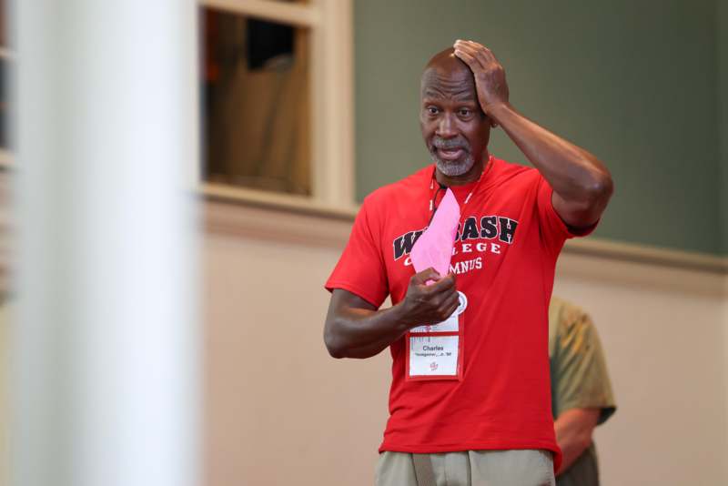 a man holding a pink piece of paper