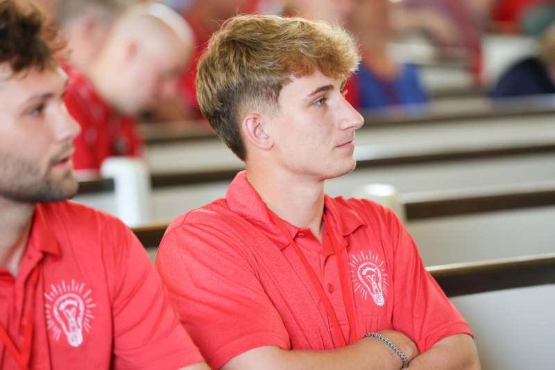 a man in red shirt with his arms crossed