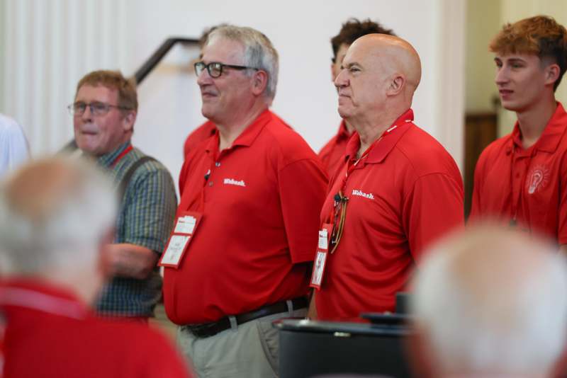 a group of men wearing red shirts