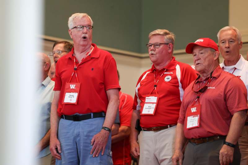 a group of men wearing red shirts