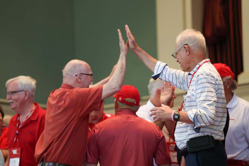 a group of men giving each other a high five