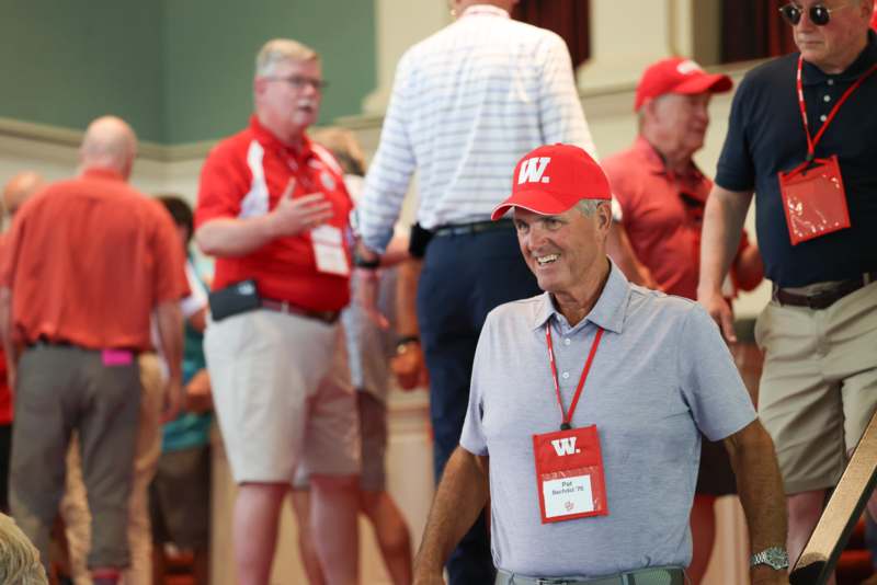 a man wearing a red hat and badge