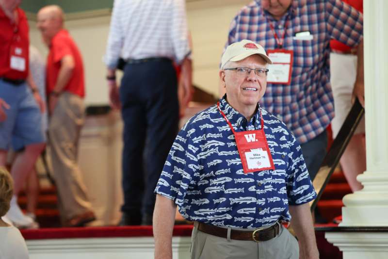 a man wearing a hat and name tag