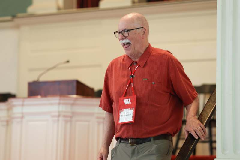 a man with a white mustache and a red shirt