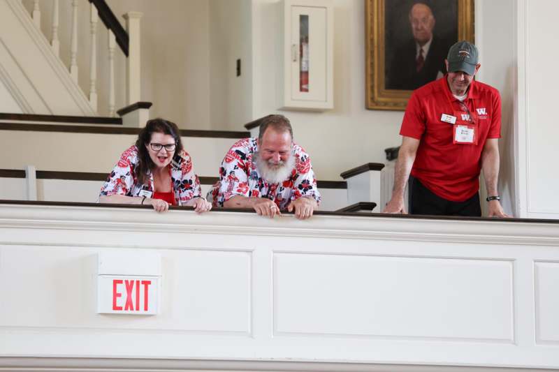 a group of people standing on a railing
