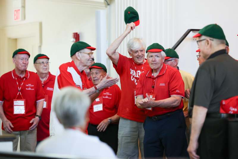 a group of old men wearing matching hats