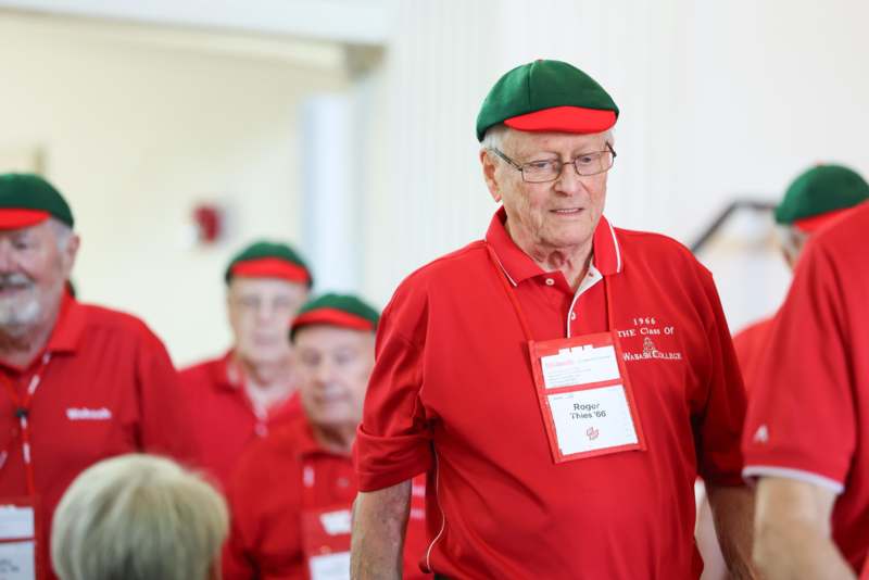 a man wearing a red shirt and green hat