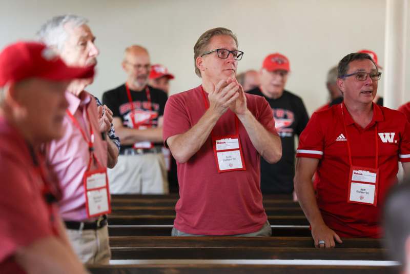a group of men standing in a church