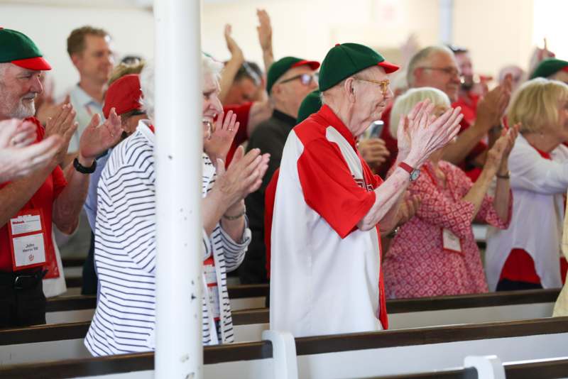 a group of people clapping in a church