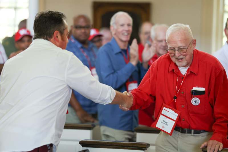 a man shaking hands with another man