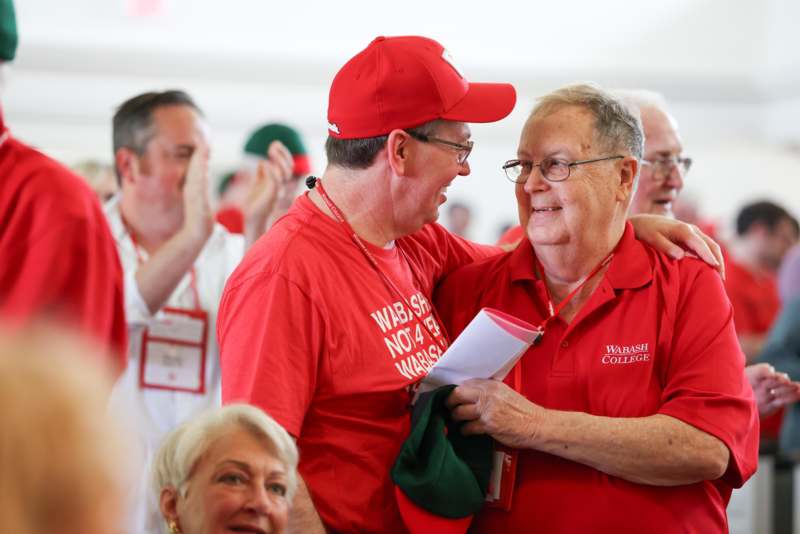 a group of men in red shirts