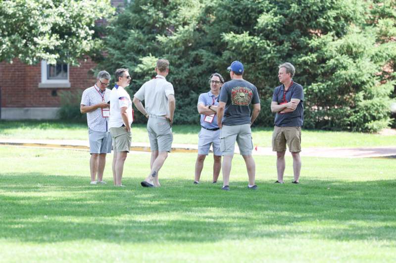 a group of people standing on grass